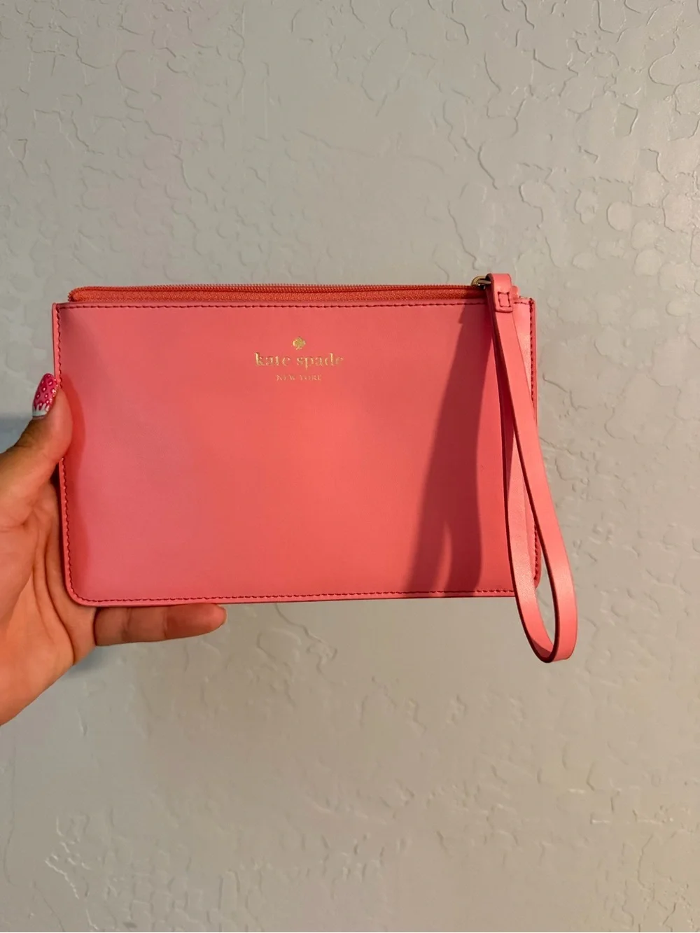 kate spade coral pink leather wristlet clutch with gold logo